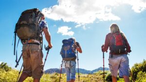 Family of three hiking through foothills of mountain